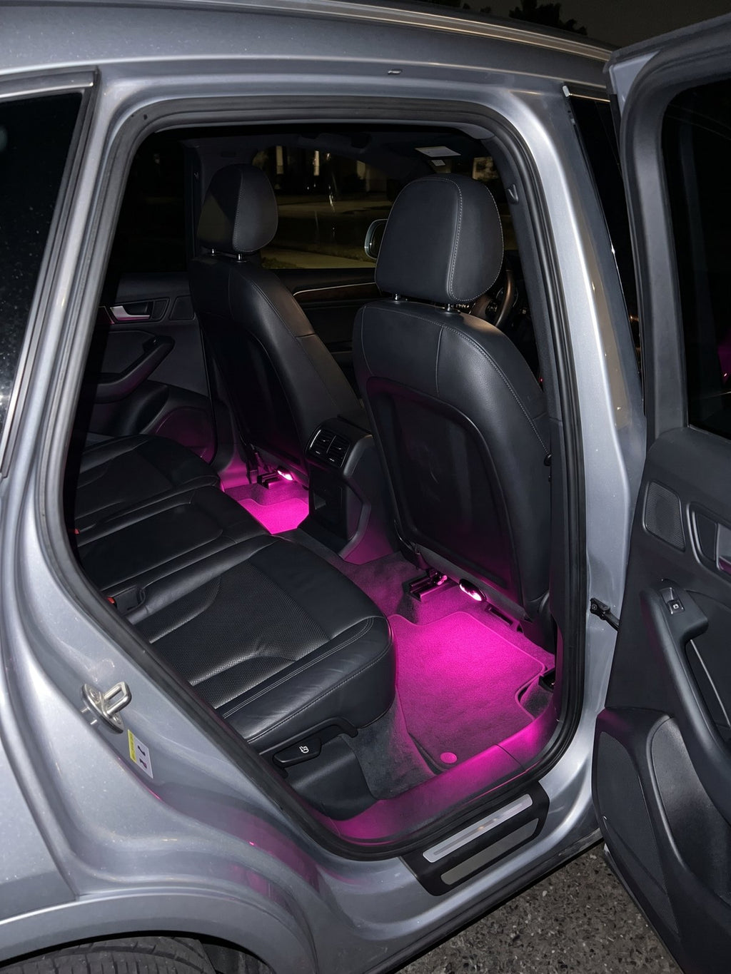 Luces de pies en magenta en las plazas traseras de un Audi Q5